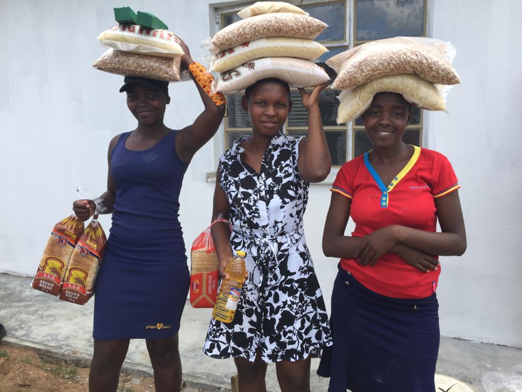 Girls carry bags on their heads